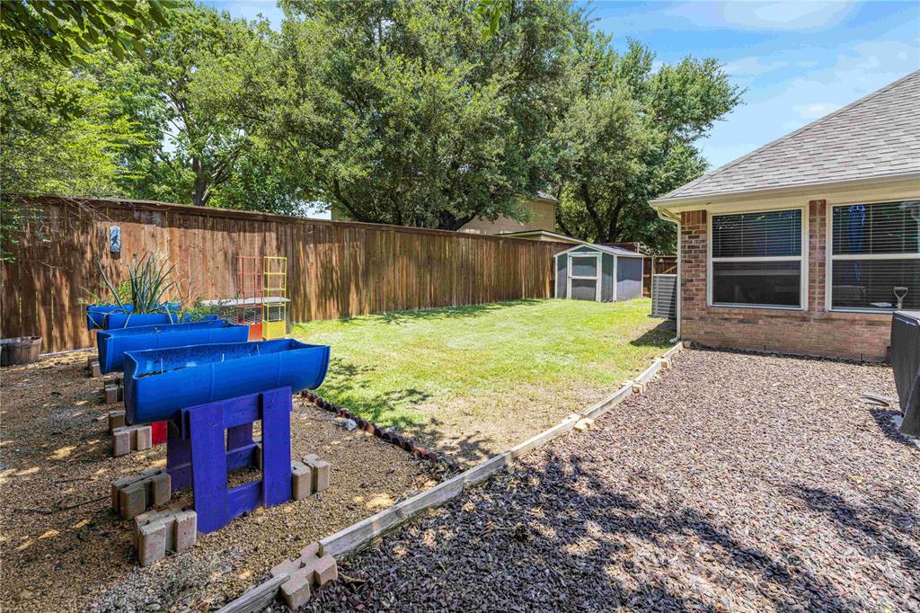 2813 Ridgemere Drive Flower Mound, TX 75028 - Photo 18 of 18 a view of a backyard with a table and chair