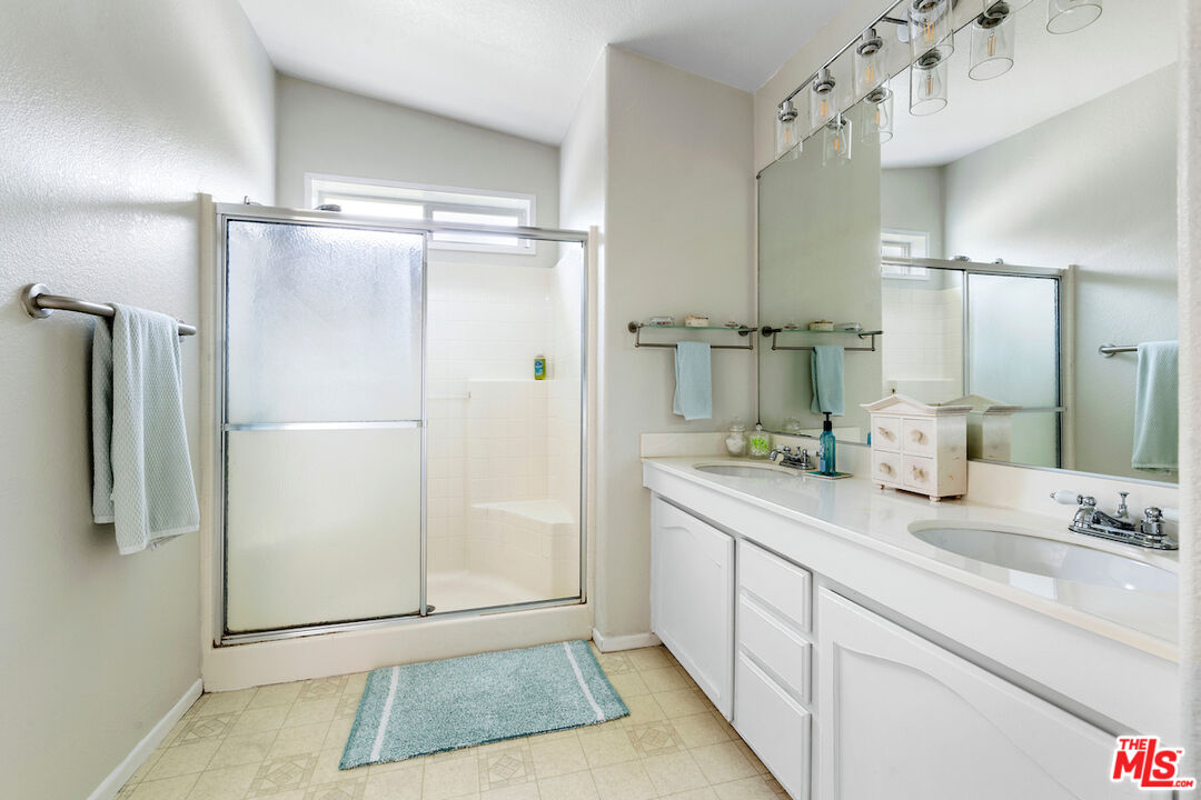 29500 Heathercliff Road, Unit 3 Malibu, CA 90265 - Photo 11 of 18 a bathroom with a double vanity sink mirror and shower