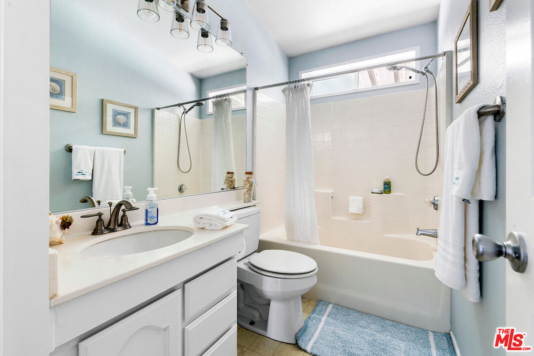 29500 Heathercliff Road, Unit 3 Malibu, CA 90265 - Photo 15 of 18 a bathroom with a sink double vanity mirror and a bathtub