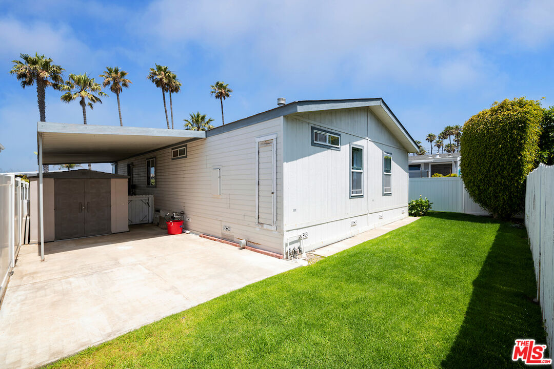 29500 Heathercliff Road, Unit 3 Malibu, CA 90265 - Photo 16 of 18 a view of a house with a backyard and a garage
