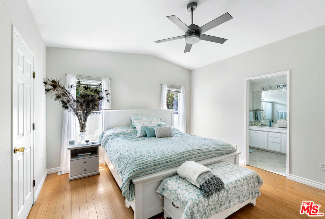 29500 Heathercliff Road, Unit 3 Malibu, CA 90265 - Photo 3 of 18 a bedroom with a bed and a chandelier