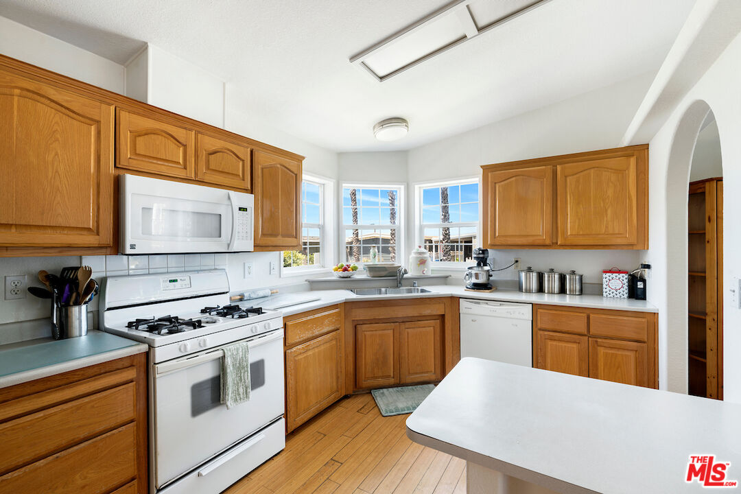 29500 Heathercliff Road, Unit 3 Malibu, CA 90265 - Photo 4 of 18 a kitchen with stainless steel appliances a stove sink and cabinets