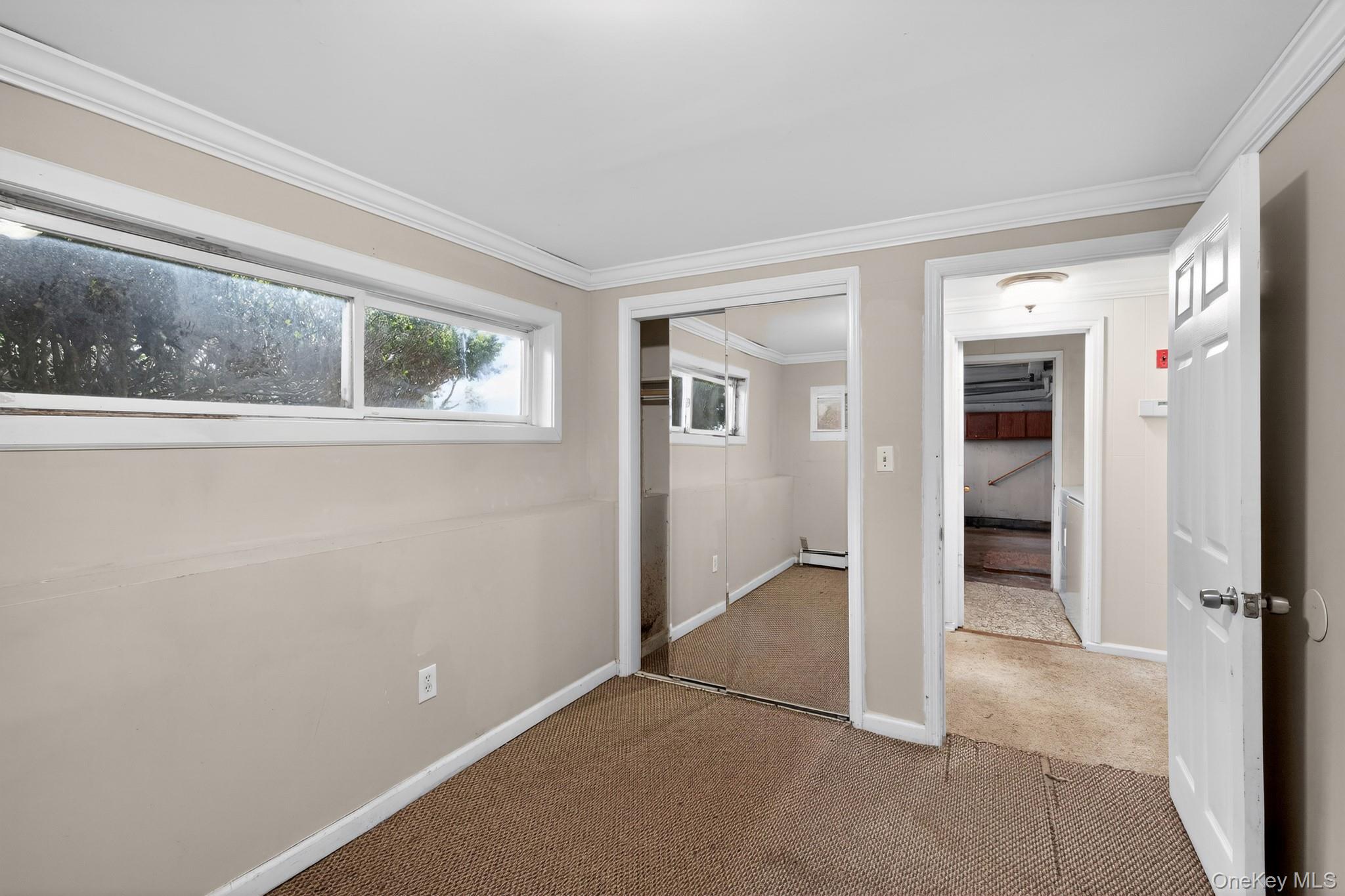 138 Spring Street Massapequa, NY 11758 - Photo 29 of 45 an empty room with windows