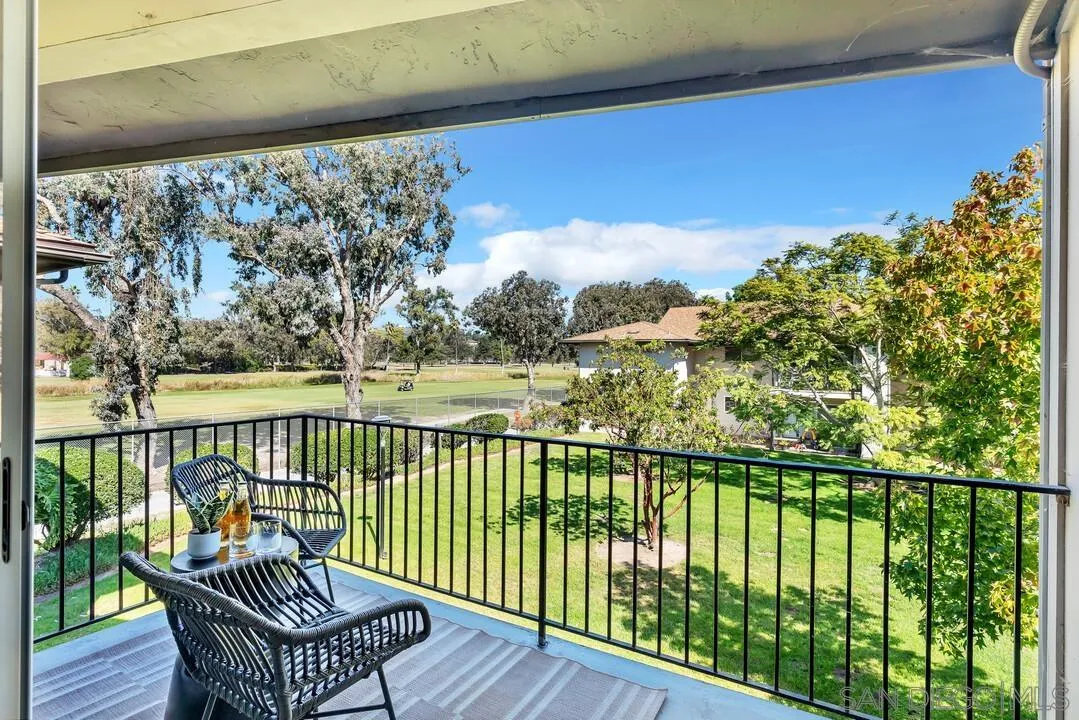 a view of a chair and table in the balcony