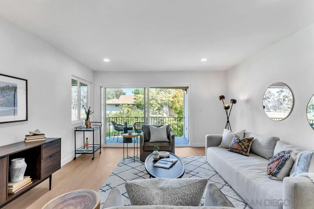 4095 Bonita Road, Unit 218 Bonita, CA 91902 - Photo 13 of 33 a living room with furniture a fireplace and a large window
