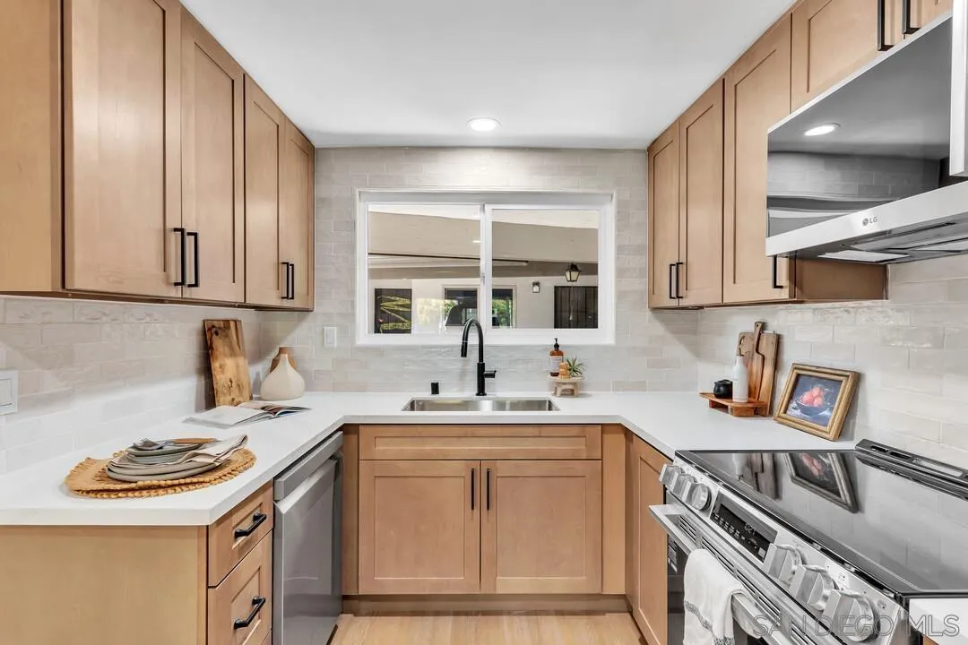 4095 Bonita Road, Unit 218 Bonita, CA 91902 - Photo 6 of 33 a kitchen with stainless steel appliances a sink stove and cabinets