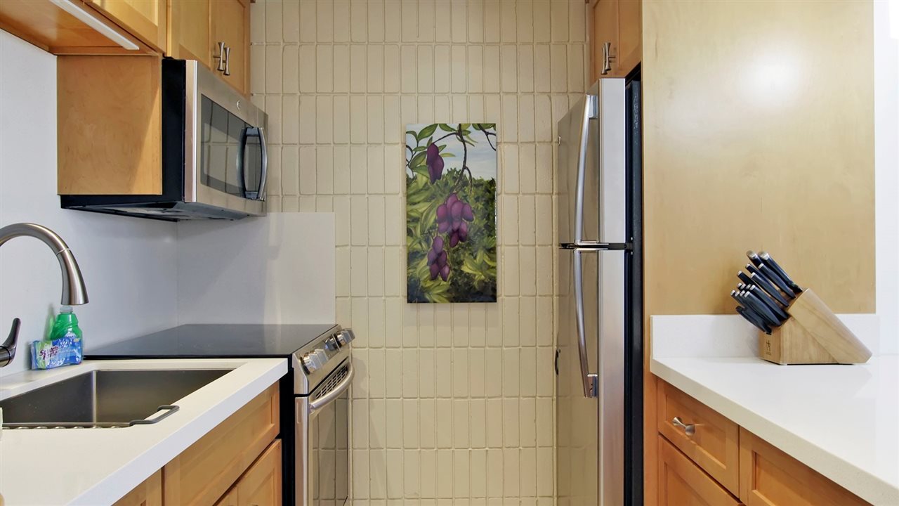 475 Front Street, Unit 624 Lahaina, HI 96761 - Photo 7 of 17 a kitchen with a sink and a refrigerator
