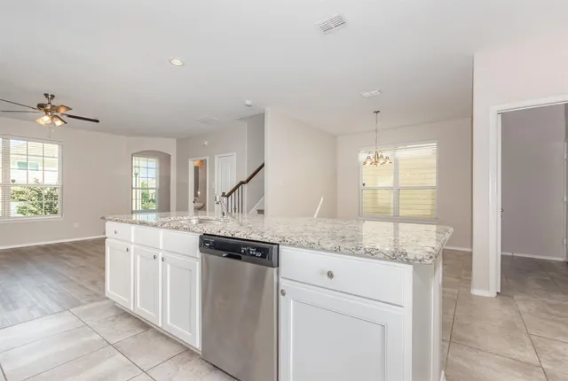 a kitchen with granite countertop a sink and cabinets