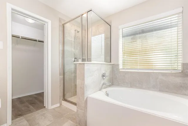 a bathroom with a bathtub and a shower