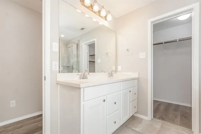 a bathroom with a sink a mirror and a shower
