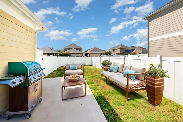 a roof deck with couches and potted plants
