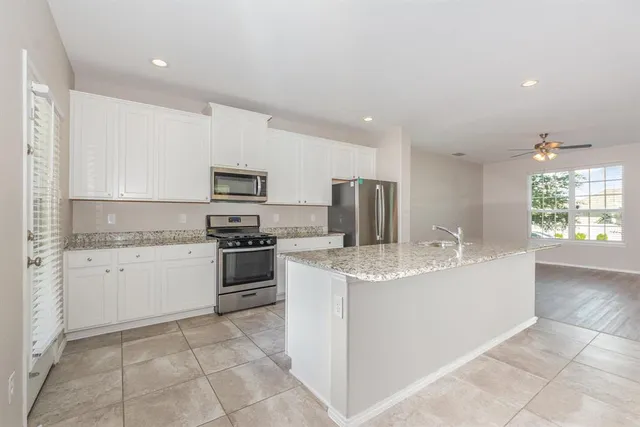a kitchen with a sink stove and microwave