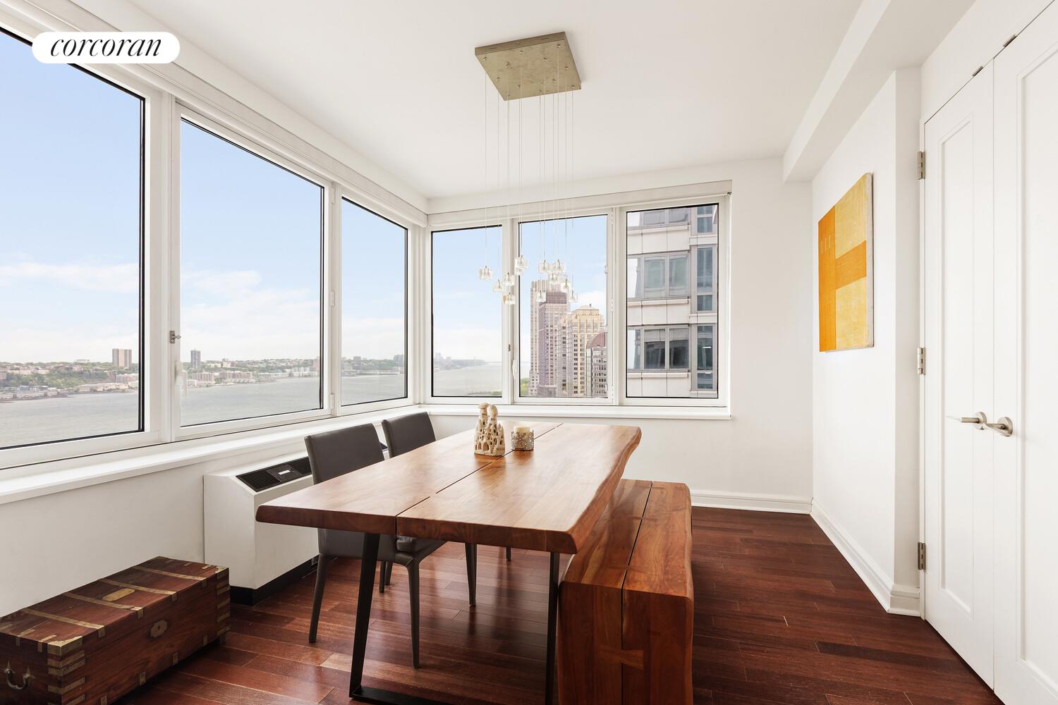 80 Riverside Boulevard, Unit 26C Manhattan, NY 10069 - Photo 2 of 6 a dining room with wooden floor and a window