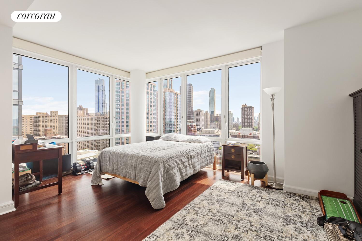 80 Riverside Boulevard, Unit 26C Manhattan, NY 10069 - Photo 4 of 6 a bedroom with a bed and a large window