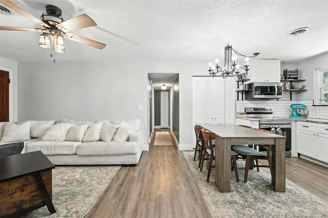 a living room with furniture and wooden floor