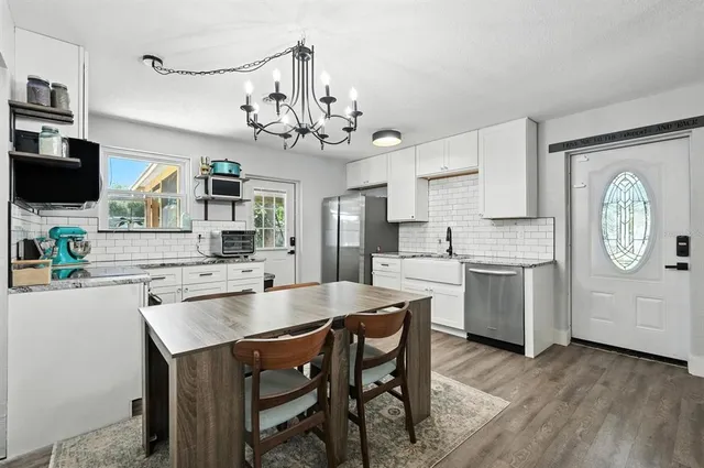 a large kitchen with a table and chairs in it