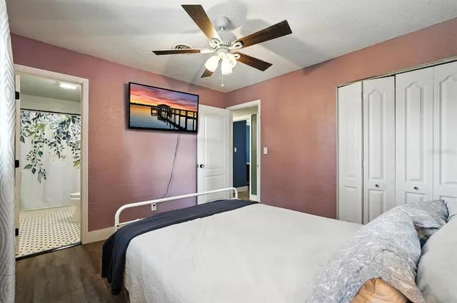 a bedroom with a large bed and a chandelier