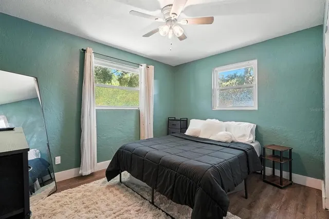 a bedroom with a bed and a window