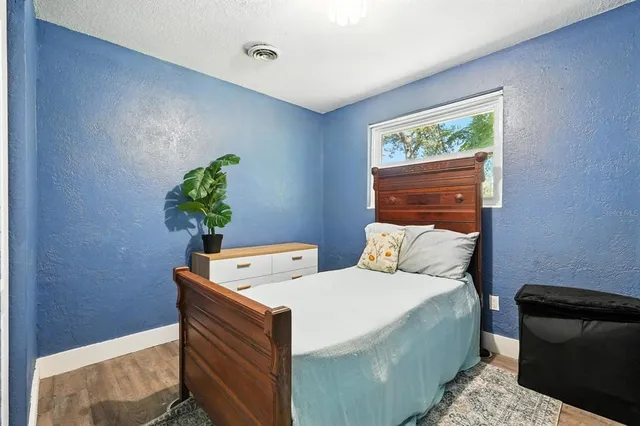 a bed room with a bed and a window