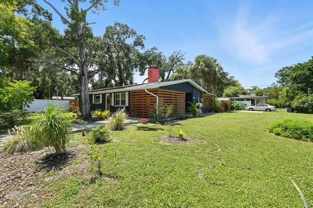 a blue house with yard in front of it