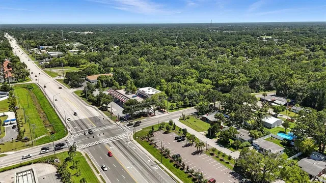 an aerial view of a residential houses with yard