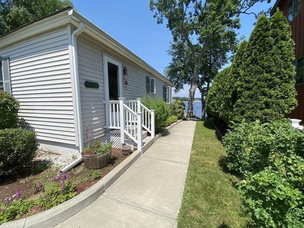 300 Killdeer Road Webster, MA 01570 - Photo 23 of 42 a view of a house with a yard and flower plants