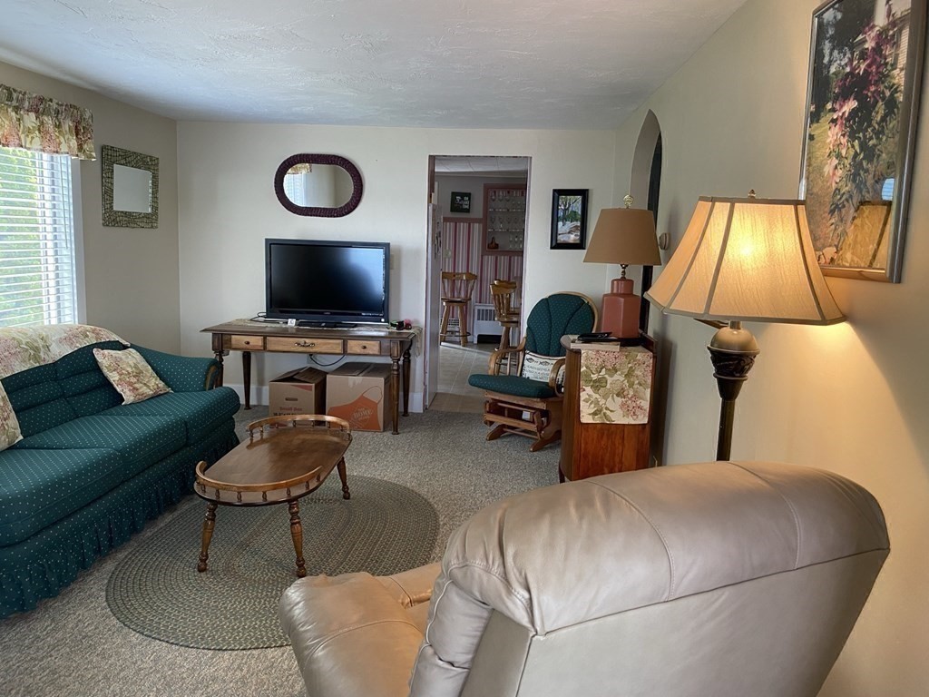 300 Killdeer Road Webster, MA 01570 - Photo 31 of 42 a living room with furniture and a flat screen tv