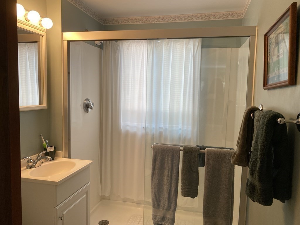 300 Killdeer Road Webster, MA 01570 - Photo 37 of 42 a bathroom with a sink a mirror and a shower