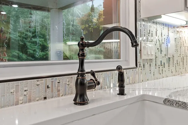 a kitchen with kitchen island a stove a sink and a refrigerator