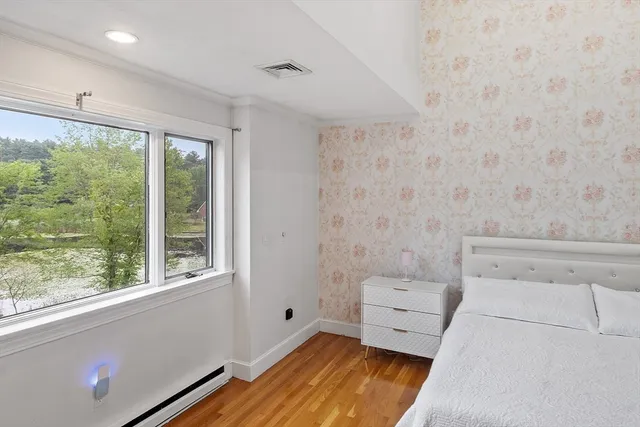 a spacious bathroom with a double vanity sink a mirror and a bathtub