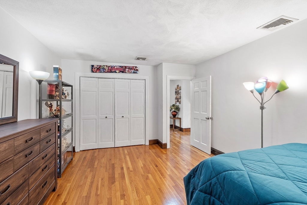 34 Wildmeadow Road Boxford, MA 01921 - Photo 31 of 40 a bedroom with a bed and a chandelier