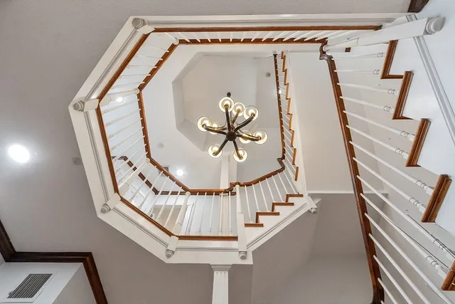 a view of staircase with railing and white walls