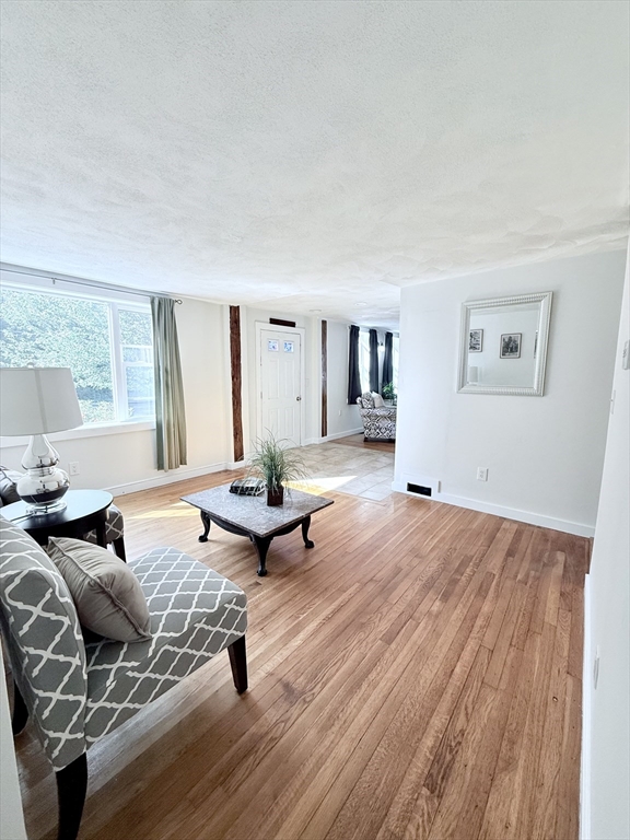 975 South Main Street Bellingham, MA 02019 - Photo 8 of 38 a living room with furniture and a wooden floor