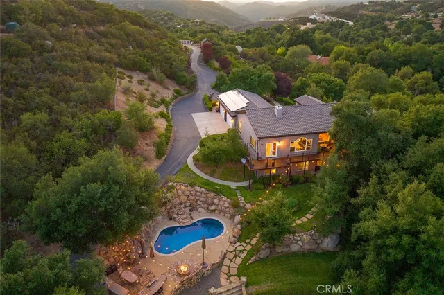 an aerial view of a house with yard