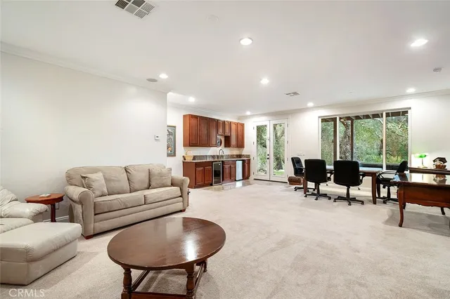 a bedroom with a bed couch and a book shelf