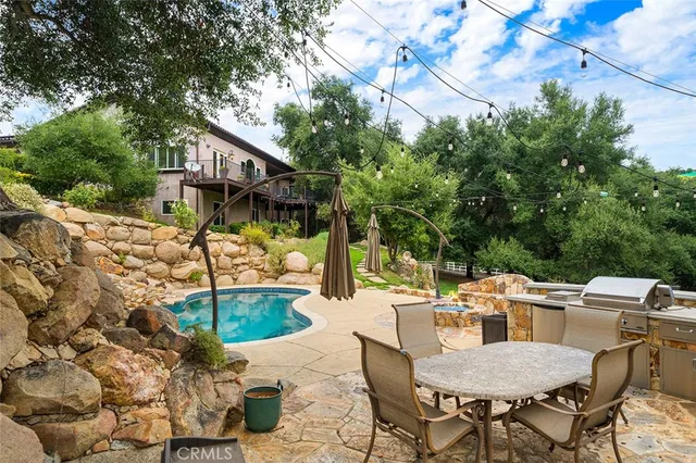 an aerial view of a house with a swimming pool