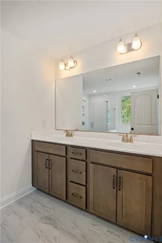 a room with a sink vanity and mirror