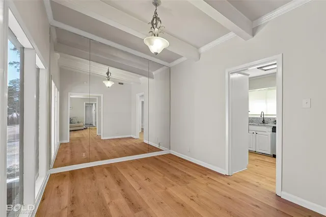 a view of a room with wooden floor and staircase