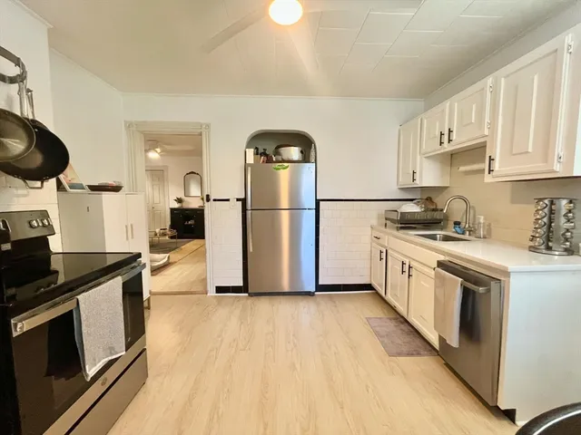 a kitchen with a sink a refrigerator and stove