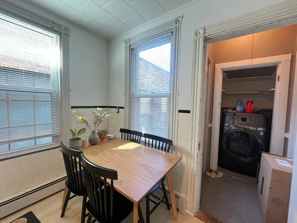 a view of a dining room that has a table and chairs in it