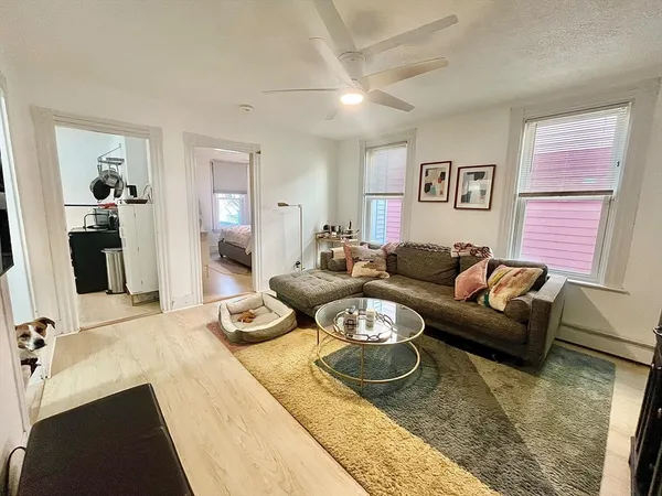 a living room with furniture and wooden floor