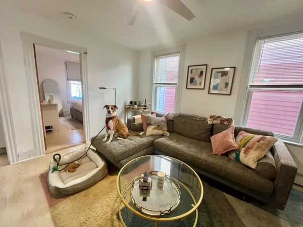 a living room with furniture and a mirror