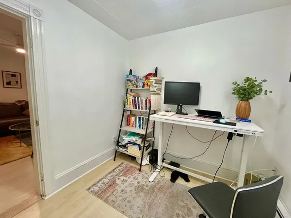 a view of a workspace with furniture and a gate