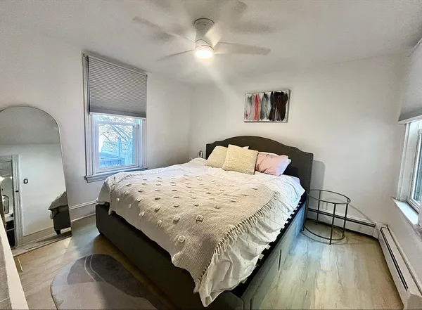 a bedroom with a bed and a chandelier