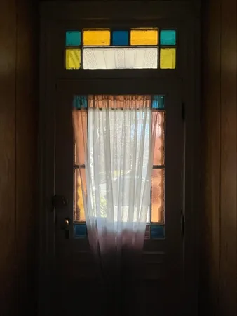 a view of empty room with two windows