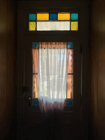 a view of empty room with two windows