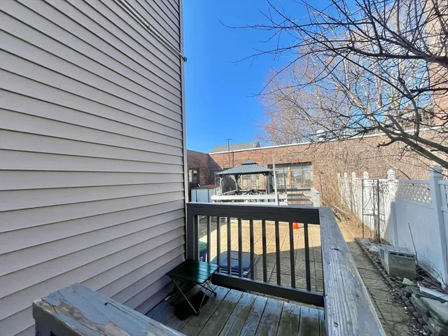 a view of a street with wooden fence