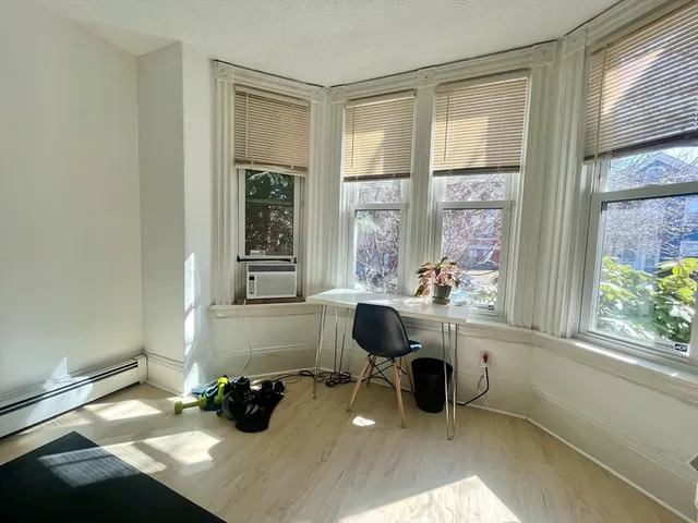 a work room with furniture and a window