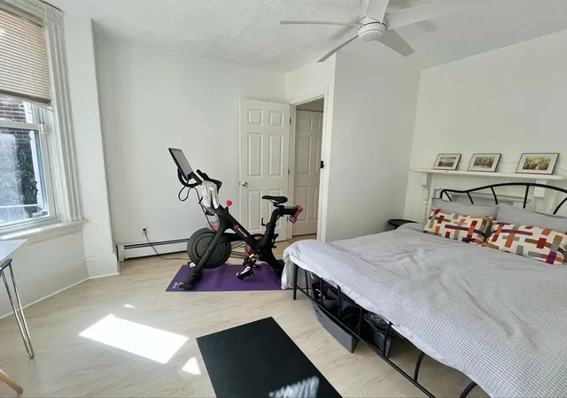 a room with a bed and a chandelier