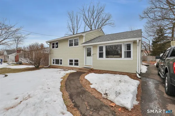 a view of a house with snow on the road